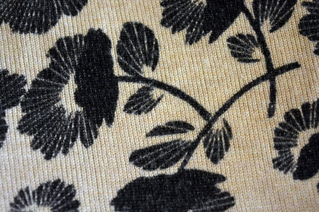 Close up detail of black and white knitted fabric texture. Beige fabric, finely weaved, dyed with...