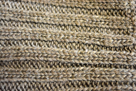 Knitted woolen texture as a background. Close-up. Women's clothing, stylish knitwear made of natural...