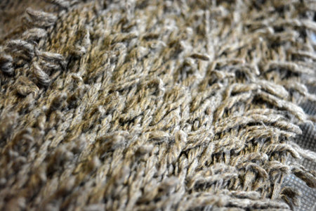 Macro detail of a woolen mop. Textured background. Texture of a knitted fabric with a pattern of...