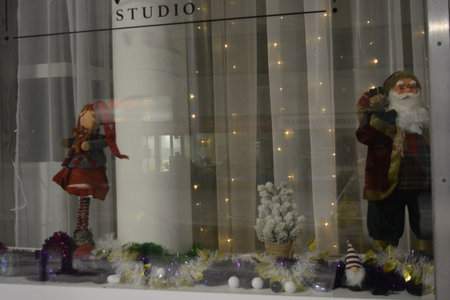 Christmas and New Year decoration in shop window with Santa Claus. New Year's toys of Santa Claus,...