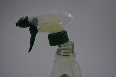 Spray bottle on white background. Cleaning and disinfection concept. Beautiful transparent bottle...