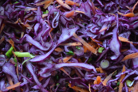 Sliced red cabbage salad with carrots and onions, close up. Healthy food, food, vegetables. Lettuce, finely chopped purple cabbage with carrots and onions.の写真素材