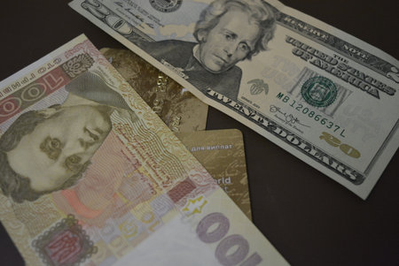 American dollars and Turkish lira banknotes on a dark background. 20 US dollars, 100 Ukrainian...