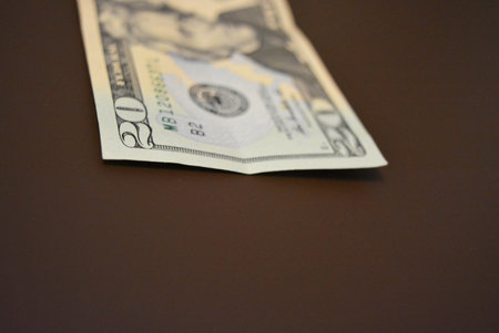 Dollars on a brown background. Shallow DOF. Economy, finance, financial literacy American dollars of...