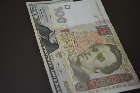 Close-up of a banknote of five thousand rubles. Things and objects that are used every day are twenty dollars and one hundred hryvnias.の写真素材
