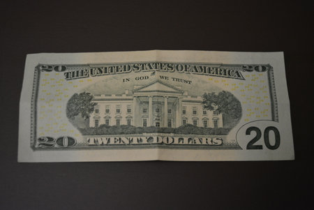 US dollar banknote on a dark background. Close-up. Economy, finance, financial literacy American...