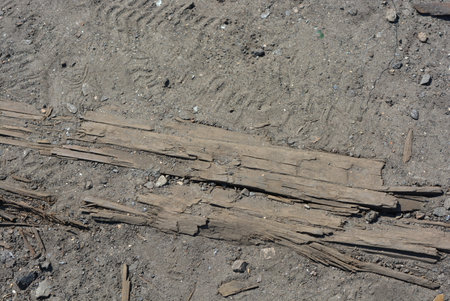 Wooden planks on the ground as a background. close-up Things, brown burnt wood, old broken sleepers...