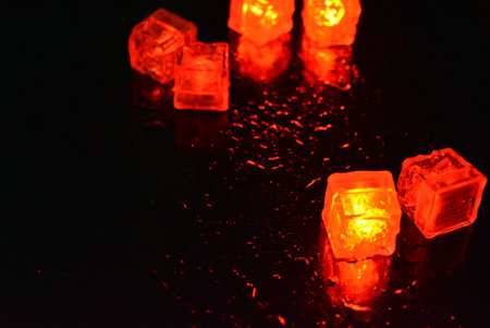 Light on black background with copy space for text or image. Beautiful and bright red glowing ice...