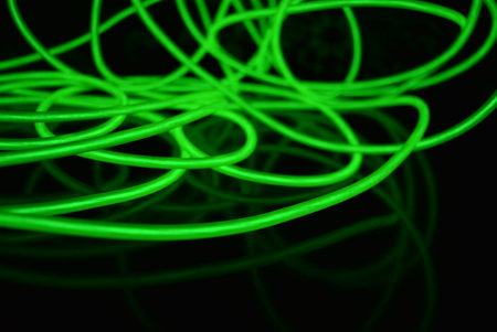 Abstract background. green neon lines on a black background. 3d render. Neon chaotic lines are...