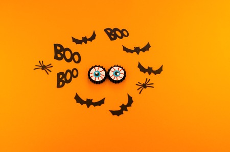 Eyes of a pumpkin monster from a paper against an orange background. Copy spase. Party holiday Halloween.の写真素材