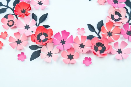 Flower and leaf of pink and black color made of paper. Handwork, favorite hobby. White background.