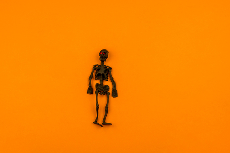 Orange background with collection of Halloween objects origami overhead view. Feared party decor. Handwork.の写真素材