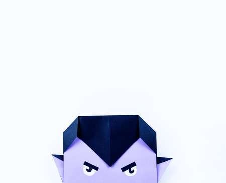 Origami Halloween. Vampire with purple skin and fangs made of paper. Copy spaseの写真素材