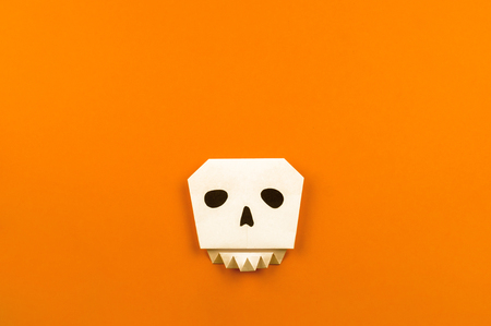 Orange background with collection of Halloween objects origami overhead view. Feared party decor. Handwork.の写真素材