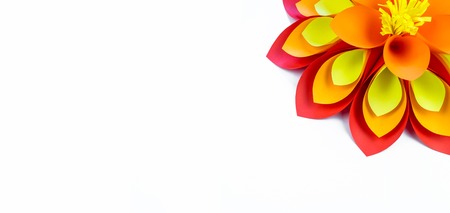 A large flower made of paper orange-red yellow colors. Decor for a kid's birthday party. Handwork.