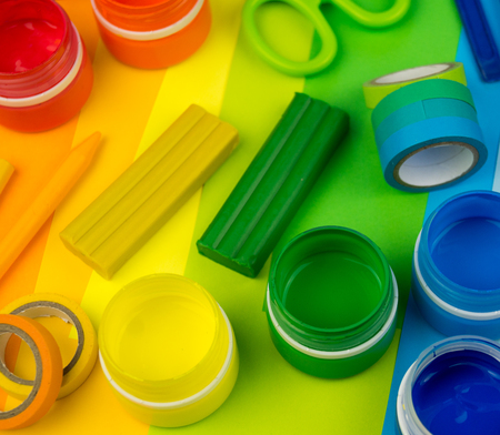 School accessories are laid out in the form of a rainbow. Black background.Happy back to school...