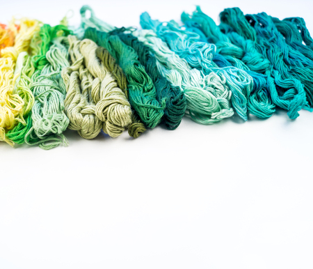 Rainbow color threads for embroidery on a white background. Favorite hobby for comfort. Craft...
