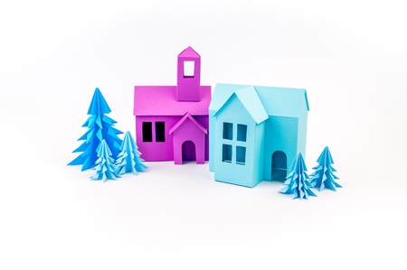 Purple and blue house glued out of paper stands in the Violet forest. White background. Children's crafts. Christmas tree.の写真素材