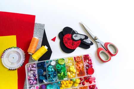 We sew a toy bullfinch from felt. New Year bird symbol. Material for decorating. Mastery is creativity.の写真素材