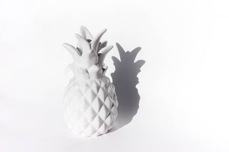 Ceramic white pineapple on a white background. Clear bright shadow. Minimalism trendの写真素材