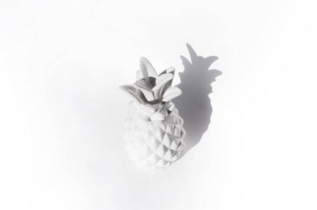 Ceramic white pineapple on a white background. Clear bright shadow. Minimalism trendの写真素材