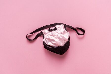 Men's underwear thong. Erotic role-playing games. Pink background. Shop of intimate goods.の写真素材