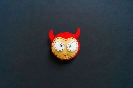 Decorative paraphernalia decoration for the holiday Halloween. Black background. Monster felt soft...