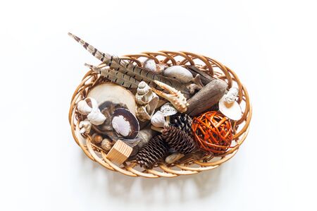Natural material montessori training. White background. Basket tray with objects for studying the...
