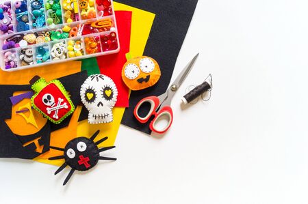 Workshop halloween decor felt toy. Spider Bat Black Cat Devil Skull Skeleton on a white background. Material for creativity and sewing. Holiday halloween.の写真素材