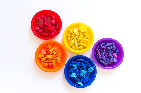 Toys for sorting by color. Bright rainbow. White background. Montessori's childcare system....