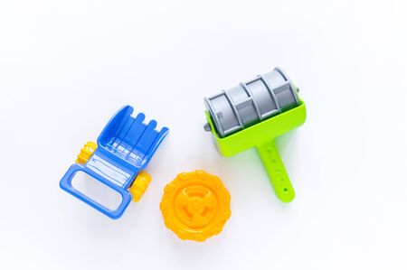 Roller toy for sand. Sand toy sea summer. Kindergarten outdoor games. The boy is playing. White background.の写真素材