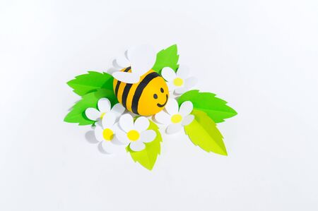 Holiday honey.One bee hack white background. Handicraft bee painted egg. Easter. Origami paper flower diy. Children's toys paperwork. School and kindergarten child development.の写真素材