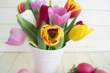 Easter holiday tulips and pink eggs. Natural background. Pastel colorsの写真素材