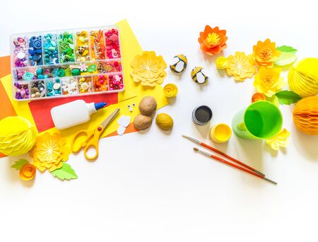 The child makes a bee crafts. Paints and material for creativity. Kindergarten and school. White backgroundの写真素材