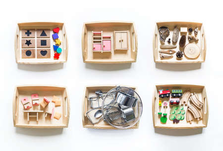 Montessori material flat lay. Banner Children hand. Home remote schooling Wooden tray on a white background.の写真素材