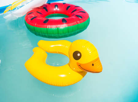 Inflatable children circles swim in the pool. Hot Summer. Empty beach without travelの写真素材