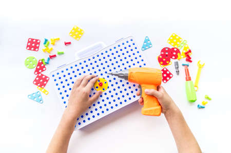 Screwdriver toy. White background. The children designer. Child plays