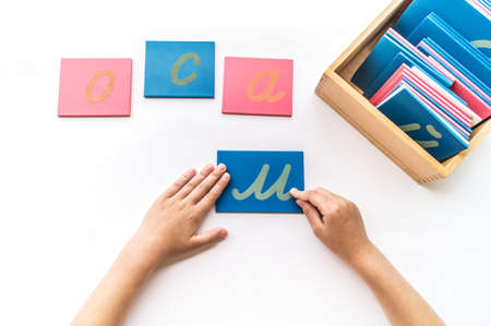 Montessori material letter flat lay. Children's hands. English alphabetの写真素材