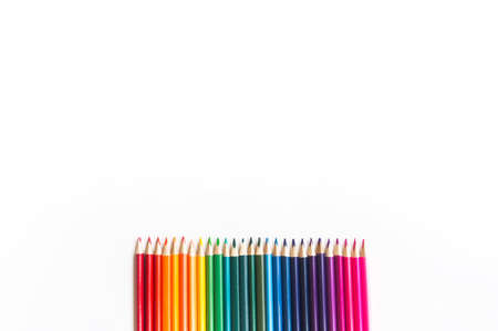 Colored pencils rainbow. White background. Back to school. Flat lay. Copy spaceの写真素材