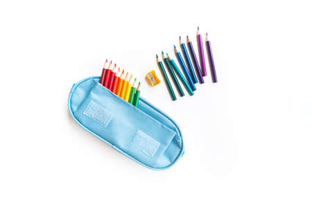Colored pencils rainbow. School pencil case. White background. Back to school. Flat lay. Copy space