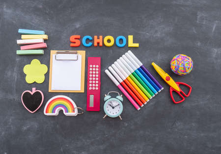 Stationery chalk board. Back to school. Bright kids office supplies. Flat layの写真素材