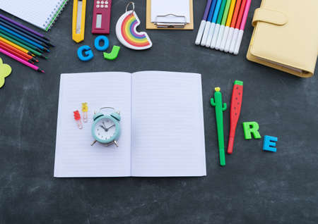 Stationery chalk board. Back to school. Open notepad on top of office supplies. Children stationery for school. Flat layの写真素材