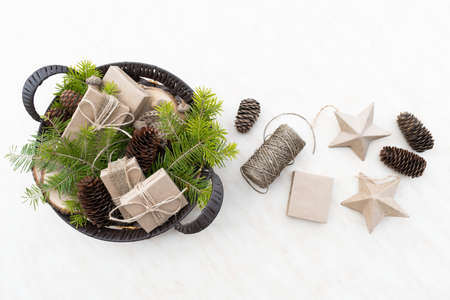 Zero waste Christmas concept. Wicker basket Hand crafted gifts with natural Christmas decorations without plastic. Flat lay, top viewの写真素材