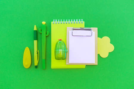 Stationery minimalism. Green background. Kawaii office supplies. Bright trend color Flat lay Copy...