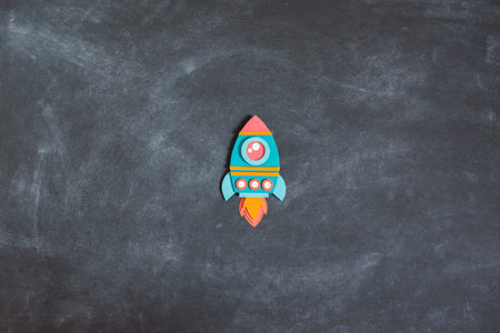 Rocket paper craft. Back to school education. Business start up concept. Paper creativity Black chalkboard backgroundの写真素材