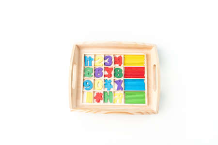 Montessori material. Hand of a child. White background. Toddler education. Study of mathematic and...