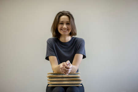 Young girl sits in a chair and holds a sadhu board in her hands. peace of mind. health concept....