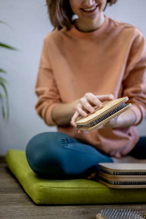 Yogi woman lays out sadhu boards with nails for group practice. yoga practice. Girl in a good mood...