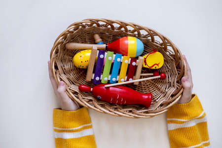 Montessori material musical instruments. Top view of the girl's hands. home school. Concept of using...
