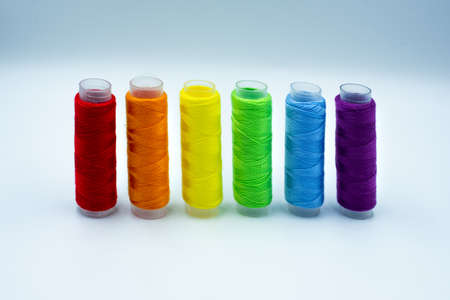Rainbow made of colourful thread spools isolated on a white background. Lgbt and love symbol....